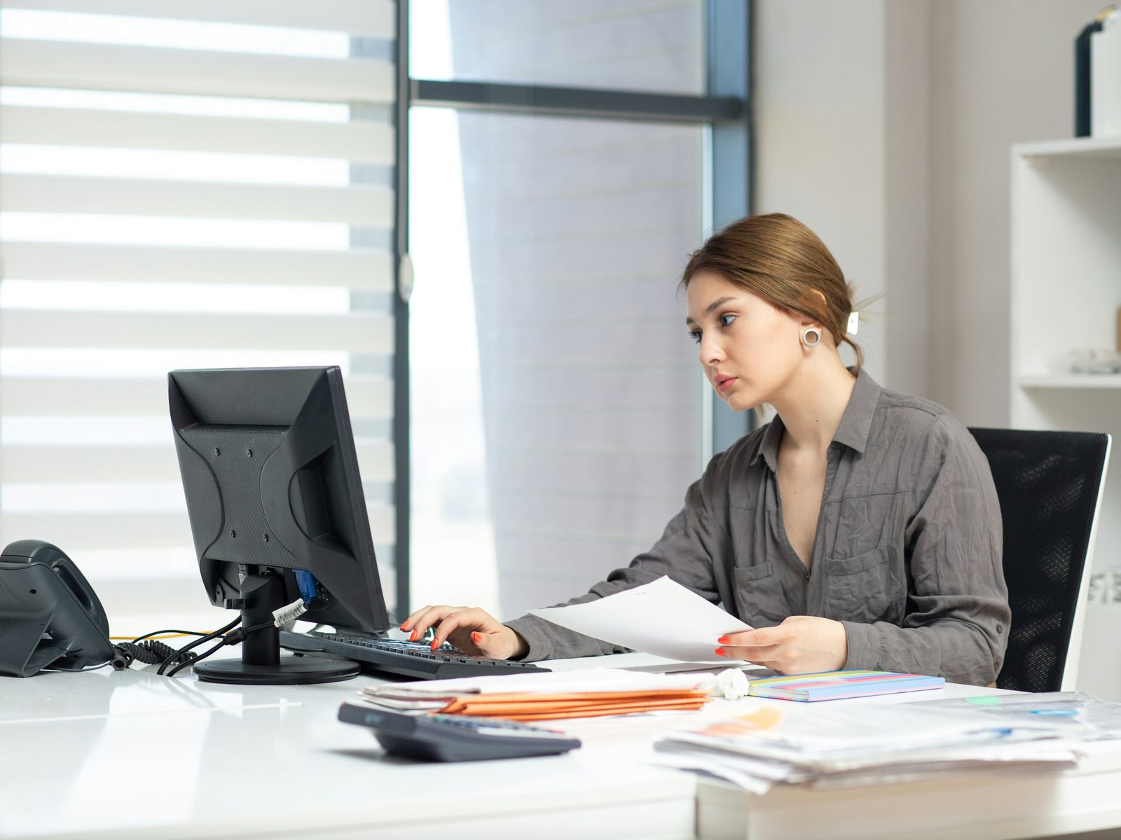 A professional working at her desk in a bright Australian business office
