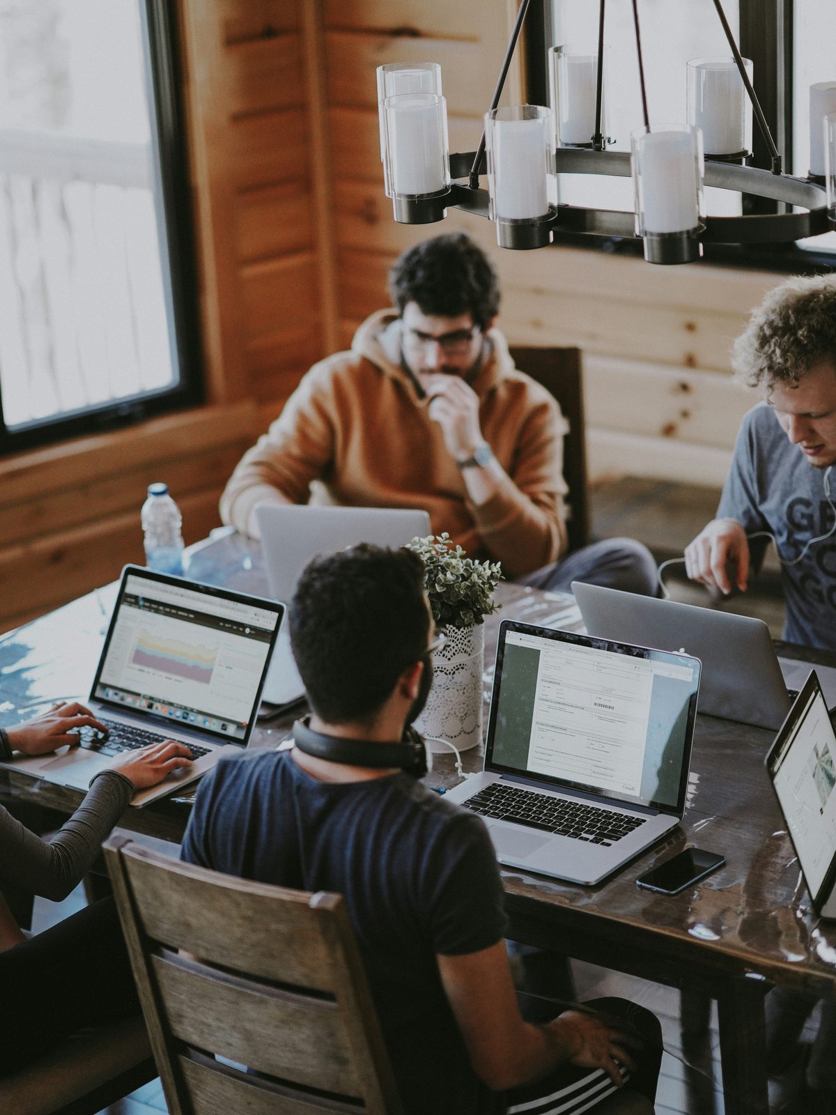 A small business team working on laptops around a shared table